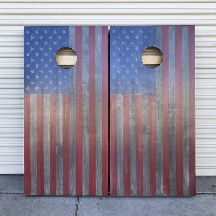Battle Worn American Flag cornhole board with garage background