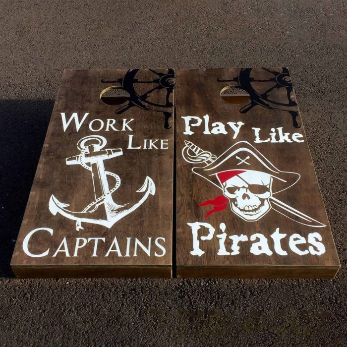 Captains and Pirates cornhole board on cement