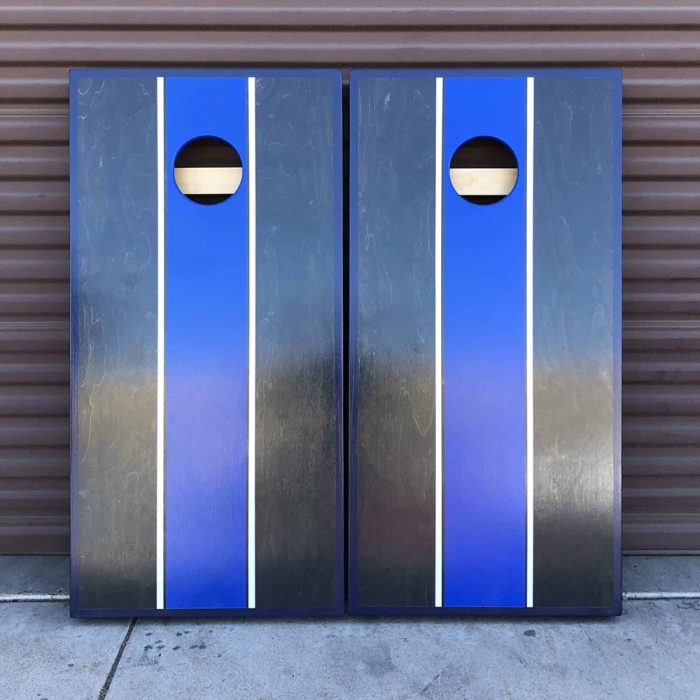 Classy Carbon Gray and Royal Blue cornhole board with garage background