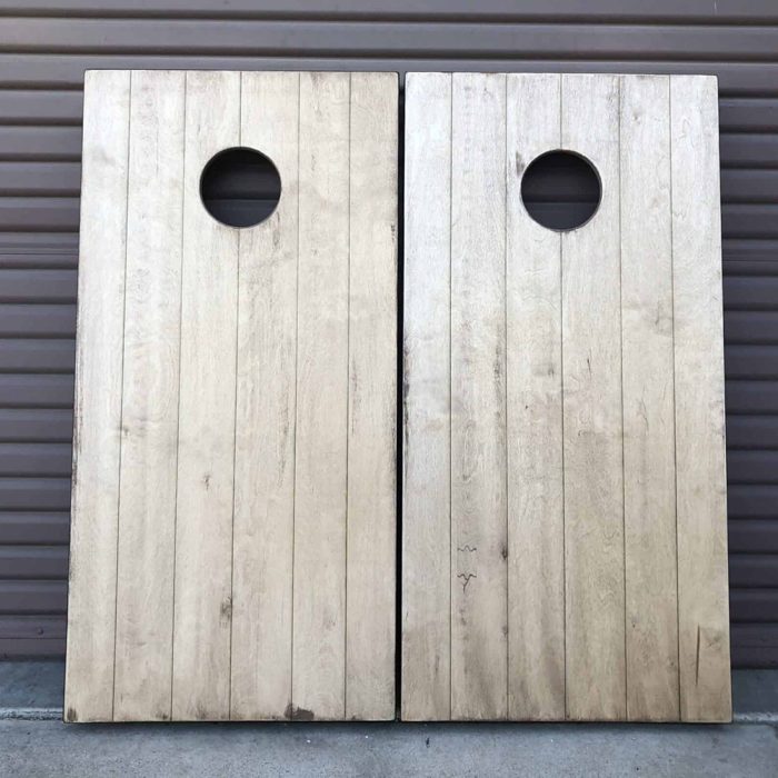 Panel Barn Wood cornhole board with garage background