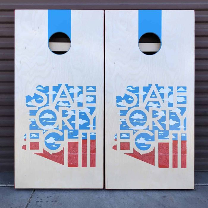 State Forty Eight Canyon and Clouds cornhole board on garage background