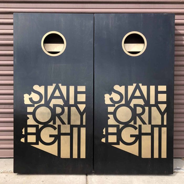 State Forty Eight Copper cornhole board with garage background