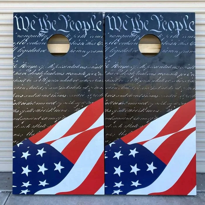 We The People patriotic cornhole board with garage background